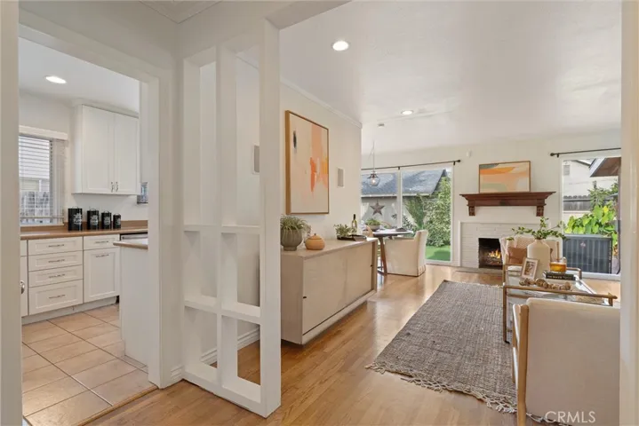 View from the end of entryway into living area and kitchen + another coat closet