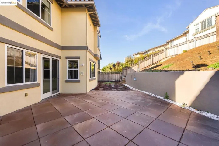 Fenced backyard with a patio