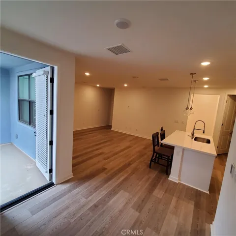 Side View of Kitchen, Family Room, & Balcony - 2nd Level