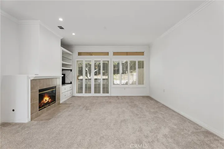 Enjoy the winter around the cozy fireplace in this inviting living room, perfect for creating warm memories all year long.