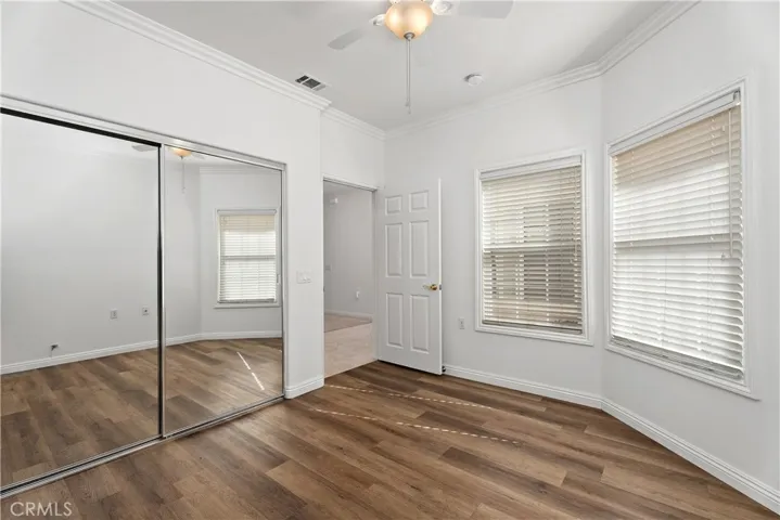 Then secondary bedroom has an abundance of light and mirrored closet doors.