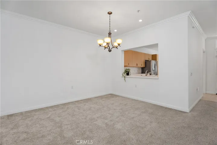 The dining area sits just off the kitchen and features a convenient pass-through, making entertaining effortless and engaging.
