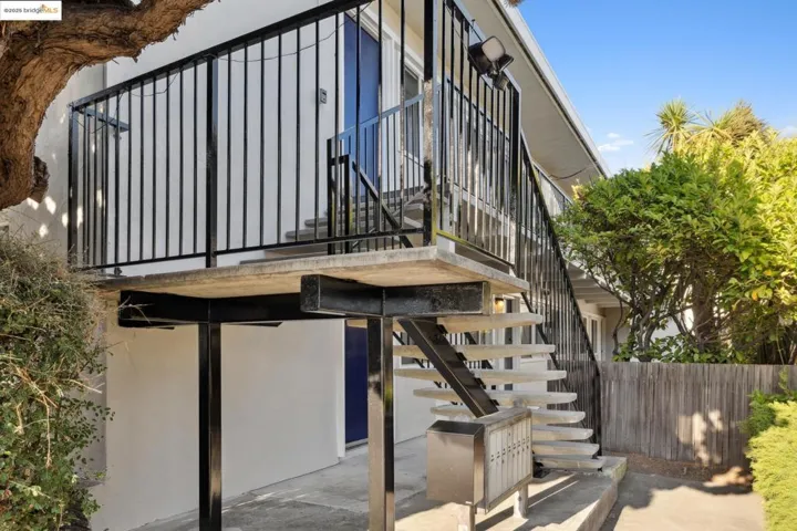 View of exterior entry with stucco siding and a patio area