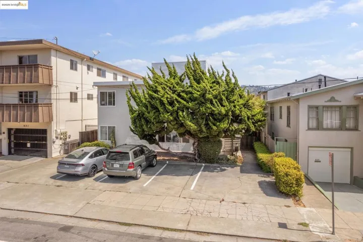 View of property featuring uncovered parking