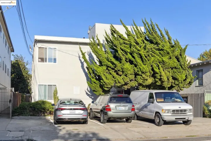 View of front facade featuring stucco siding and uncovered parking