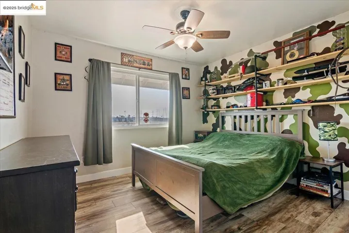 Bedroom featuring light wood-style flooring and a ceiling fan