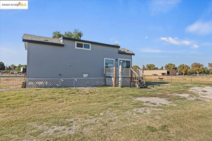 Back of property with a wooden deck