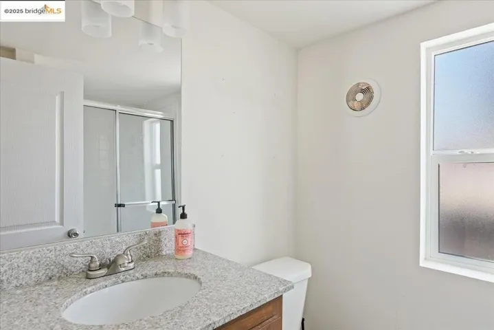 Bathroom with vanity and a shower stall