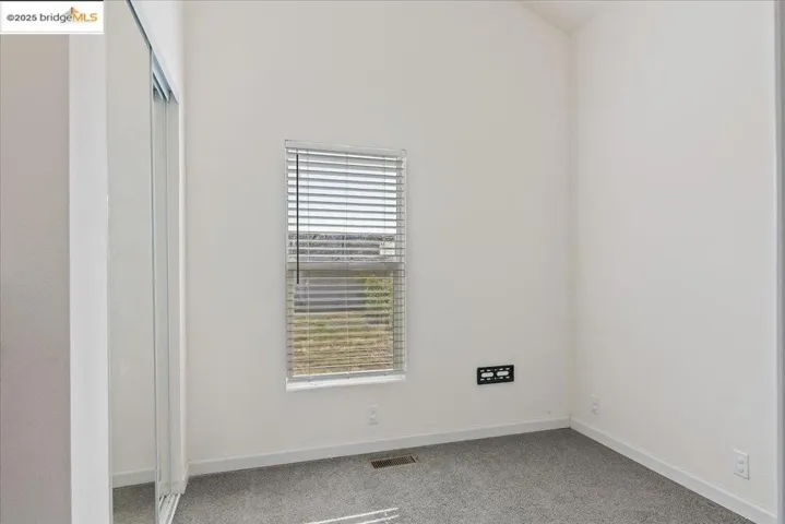 Unfurnished bedroom featuring carpet and a closet