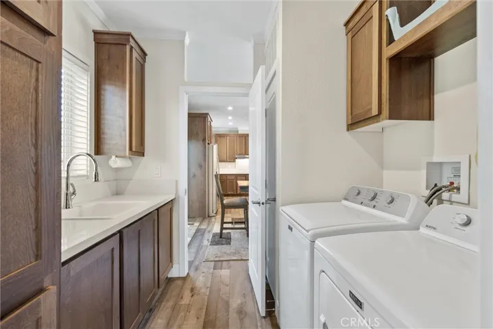 Large Laundry Room With Utility Sink and Numerous Cabinets.  Quick and Convenient Access to Dining Room and Kitchen