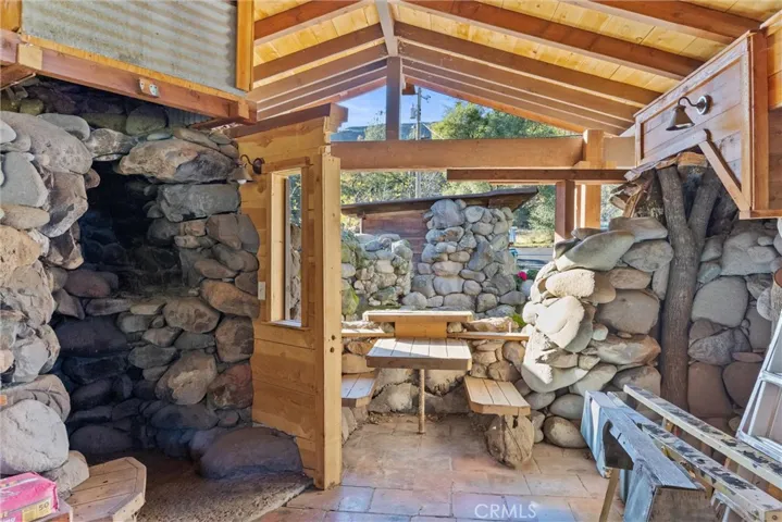 Cabin Interior with Rock Wood Stove Area and Built-In Dining Area