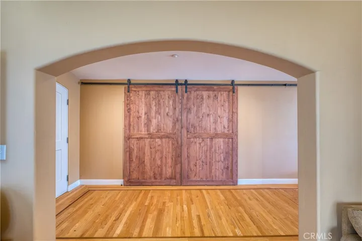 Behind these stationary barn doors is the former dining room now being used as a 4th bedroom