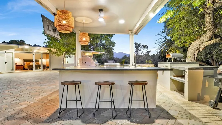 Seating on one side of Outdoor Kitchen. Mountain views in back ground.