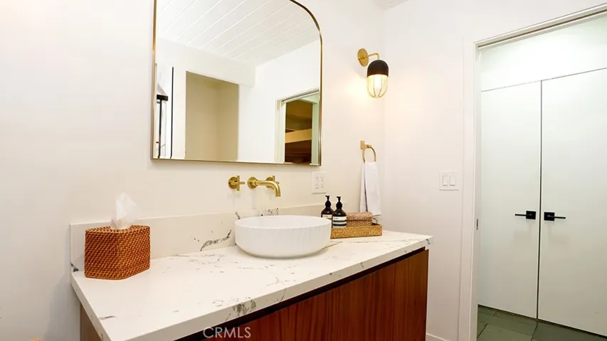 Hall Bathroom. Doors that can be seen to the right are to the Laundry Area.