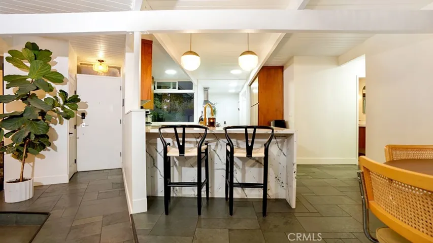 Counter seating facing kitchen. Front door is to the left.