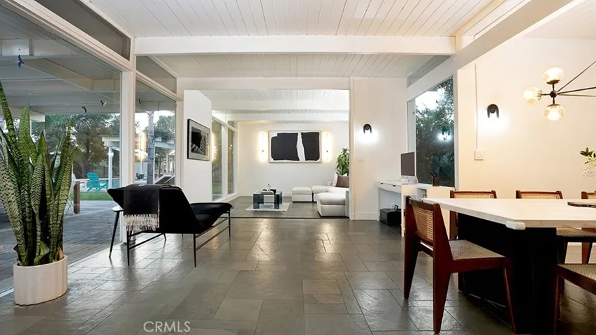 Formal Dining Area looking into Living Room. Beautiful Wall of Windows on the left looking out towards Back Yard.