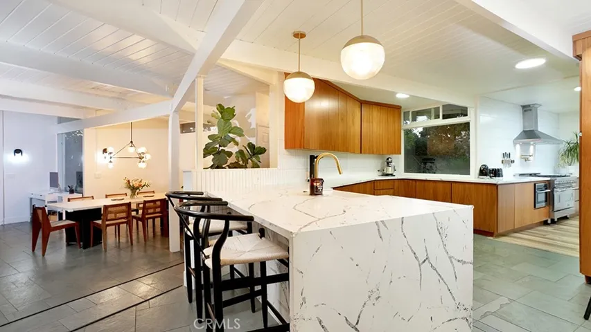 View of Kitchen and Dining Room. Notice the beautiful Beamed Ceilings throughout.