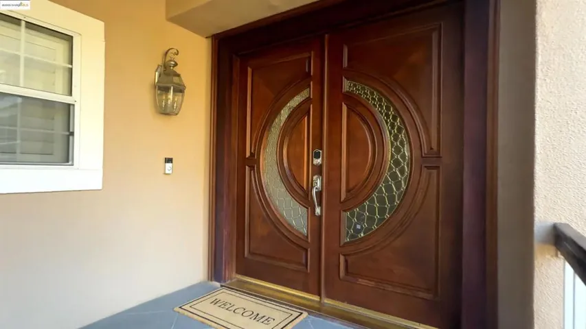 Doorway to property with stucco siding