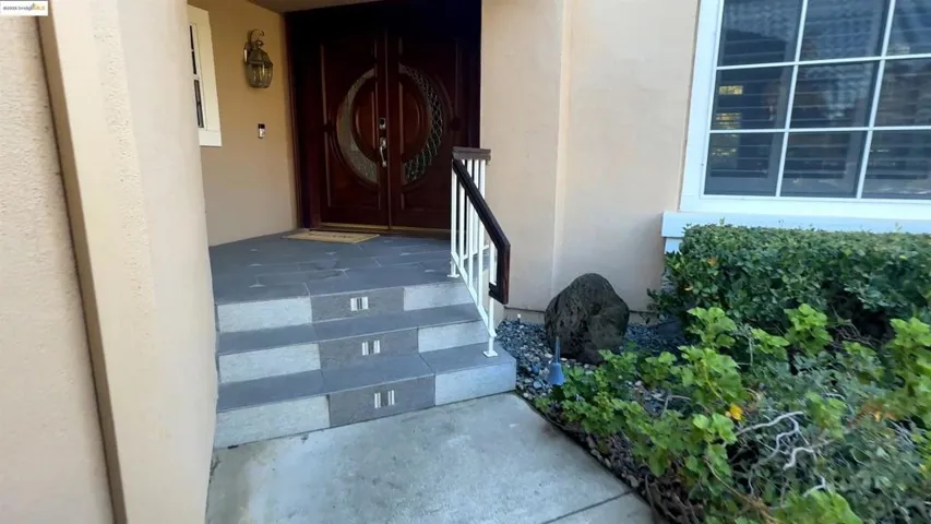 Property entrance with stucco siding