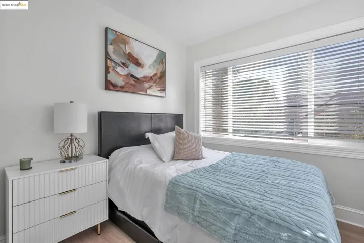 Bedroom featuring wood finished floors and baseboards