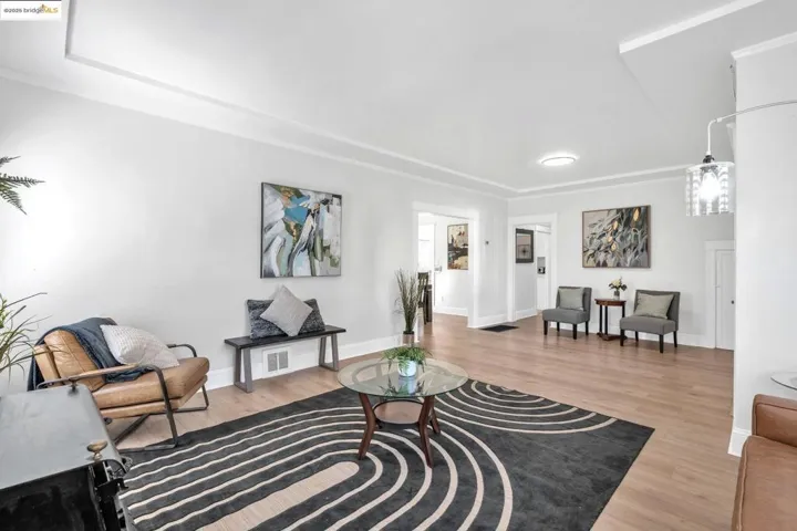 Living room with light wood-type flooring and baseboards