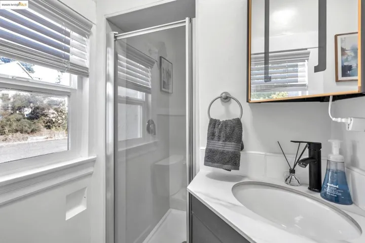 Bathroom featuring vanity and a shower stall