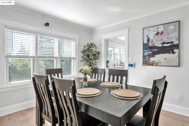 Dining space featuring light wood-type flooring and crown molding