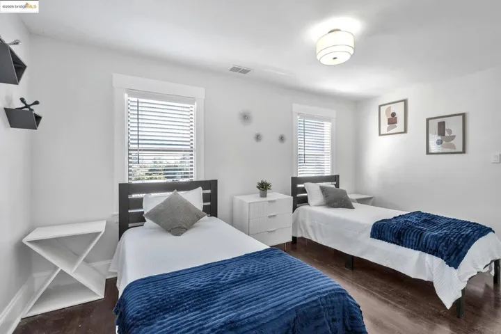 Bedroom with dark wood finished floors and baseboards