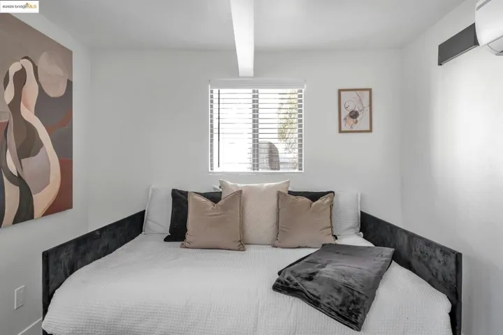 Bedroom featuring an AC wall unit