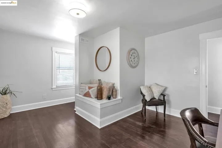 Sitting room featuring dark wood-type flooring