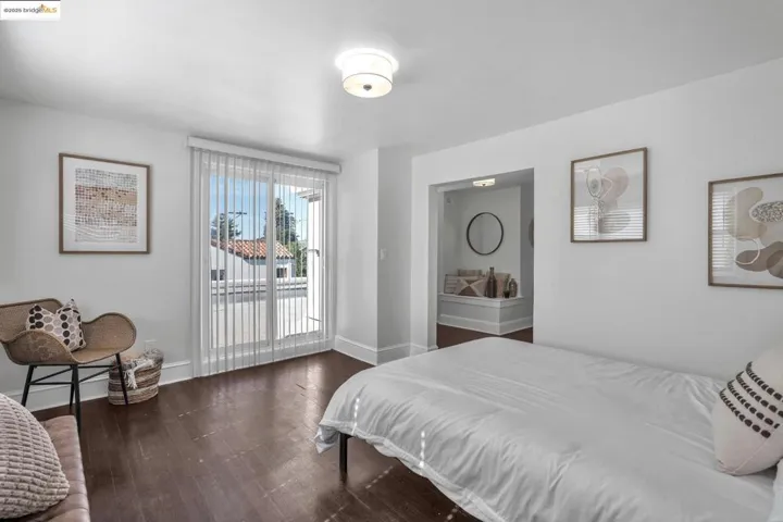 Bedroom featuring access to exterior and dark wood-style floors