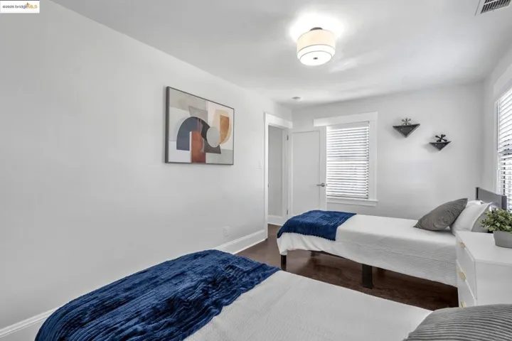 Bedroom featuring baseboards and wood finished floors
