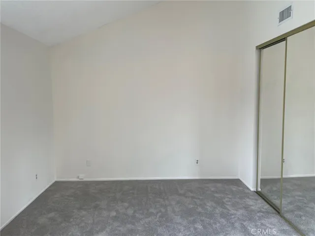 Master bedroom with high ceilings and a private bathroom