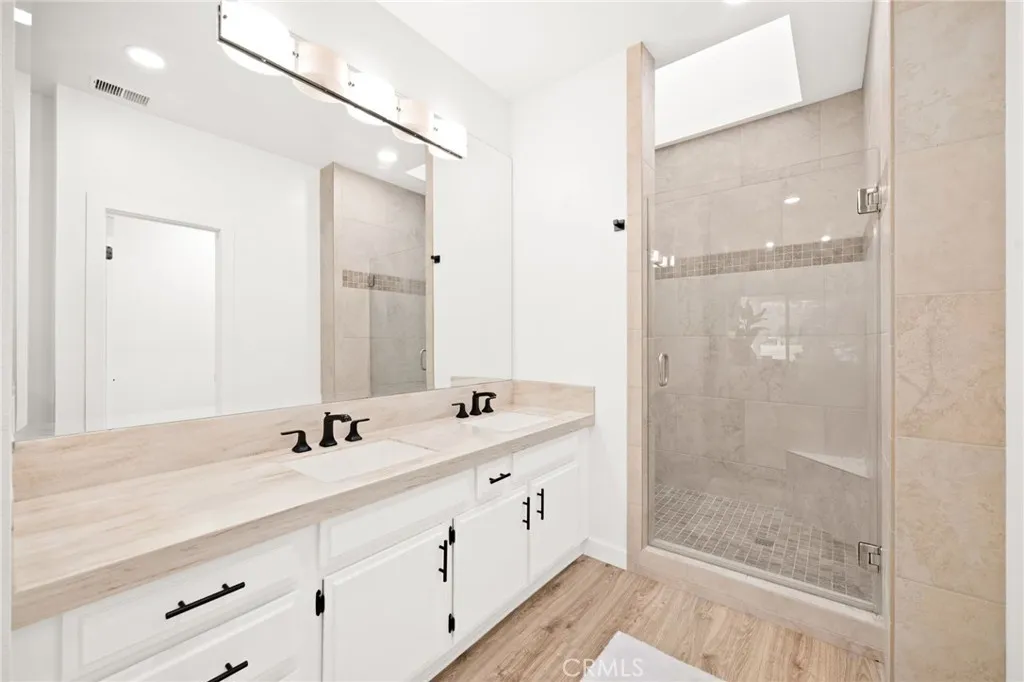 Well-appointed ensuite with dual vanity and updated finishes