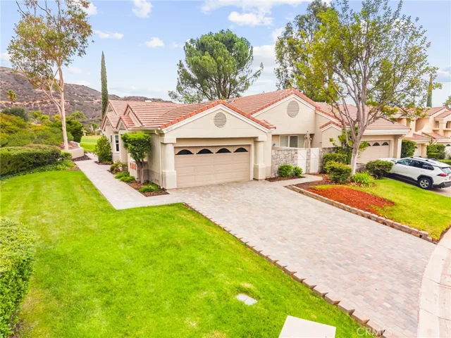 Spacious driveway with additional parking and direct access to the private primary front patio