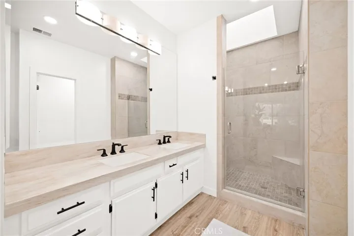 Well-appointed ensuite with dual vanity and updated finishes