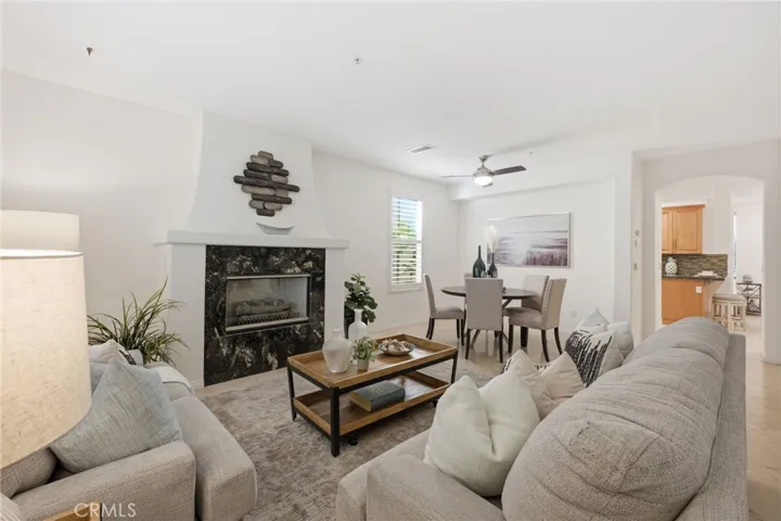 As you enter the property you are greeted with a beautiful fireplace in the living room and a formal dining room beyond.