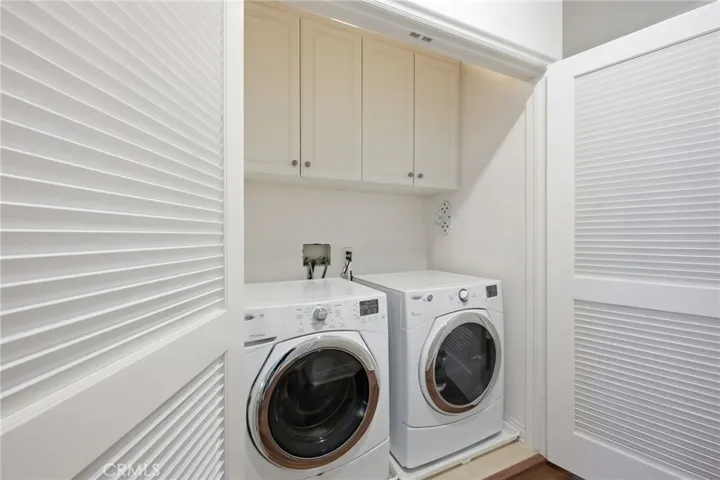 Laundry facilities are located in a closet on the upstairs level between the 2 bedrooms.