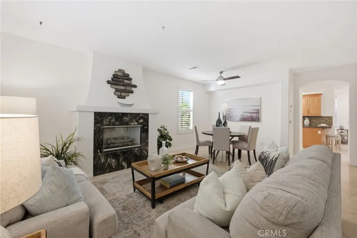 As you enter the property you are greeted with a beautiful fireplace in the living room and a formal dining room beyond.