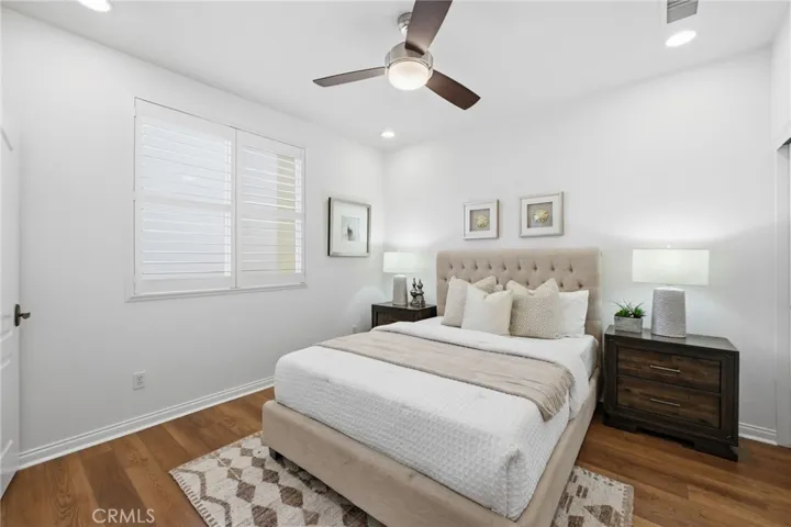 The 2nd bedroom upstairs is ensuite, with an attached bathroom, shutters on the windows and a large closet with mirrored closet doors.