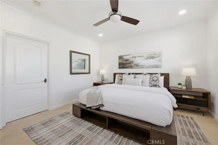 The primary suite is a great space with lots of light, thru the shuttered window. There is a ceiling fan in addition to the newer AC unit in the home.