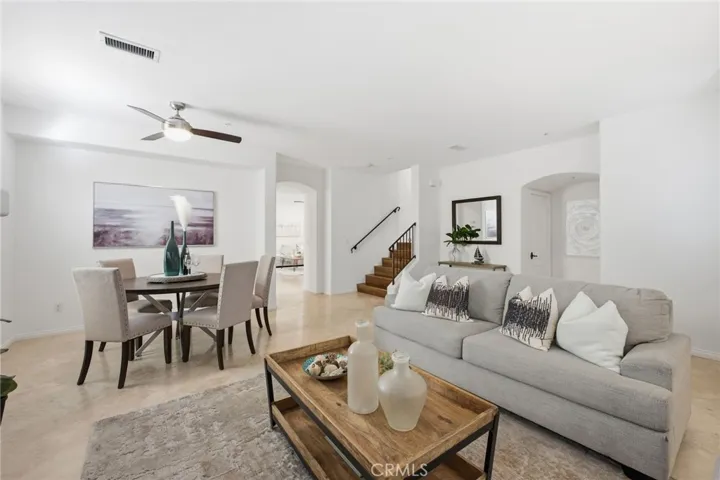 Welcome to the spacious 328 5th St. In Huntington Beach. Here is the spacious living room/dining room with a peek of the family room & Kitchen beyond and the staircase leading up to the bedrooms.
