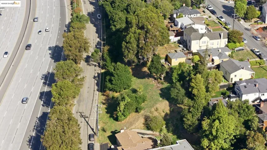 Aerial view of property and surrounding area with nearby suburban area