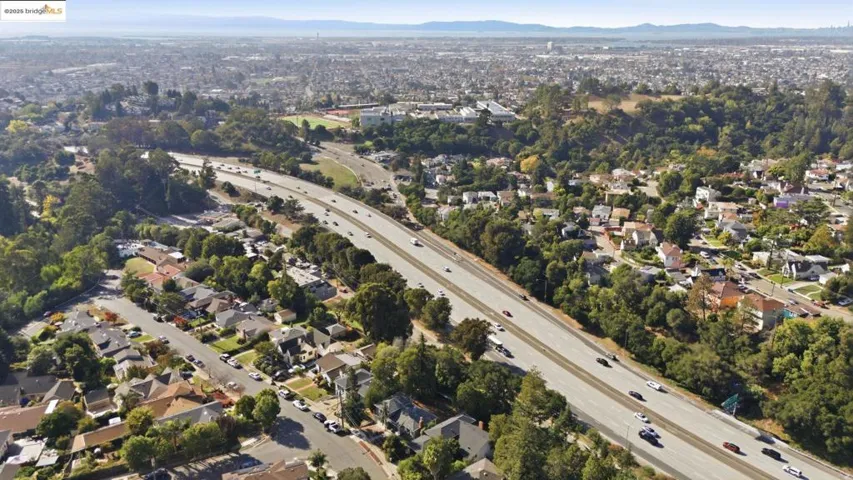 Aerial overview of property's location featuring nearby suburban area and mountains