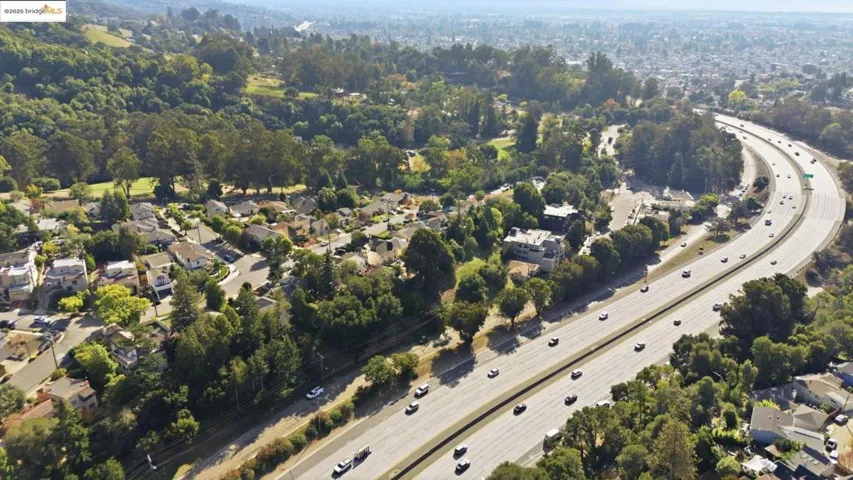 View of property location with a major roadway and nearby suburban area