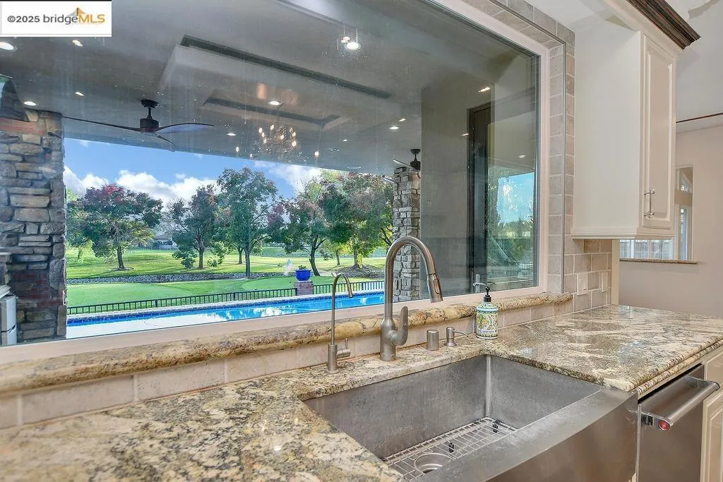 Kitchen with light stone countertops and backsplash