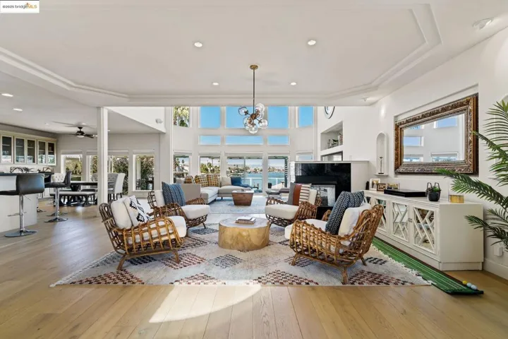Living area featuring a premium fireplace, recessed lighting, wood-type flooring, and a ceiling fan