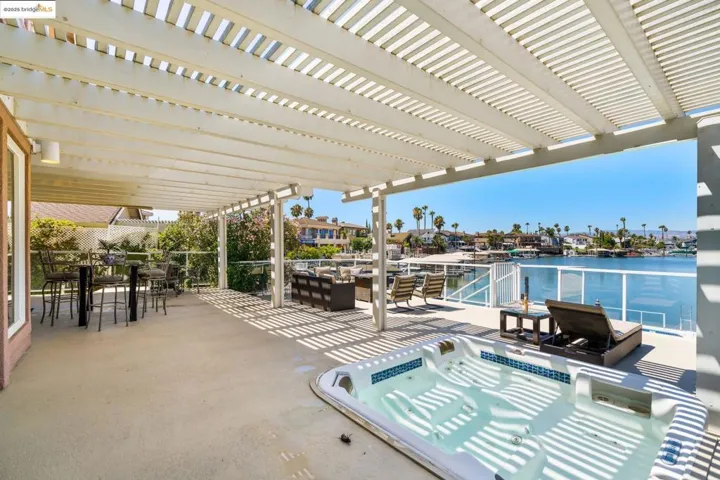 View of patio with a water view, outdoor dining area, and an outdoor hangout area