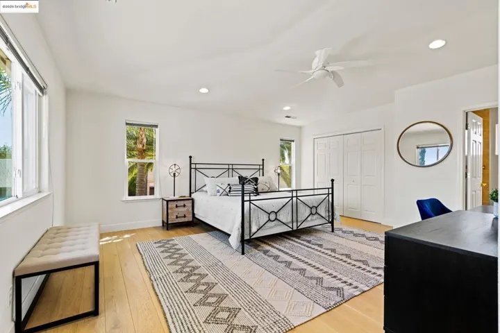 Bedroom with recessed lighting, a closet, a ceiling fan, and light wood-style floors