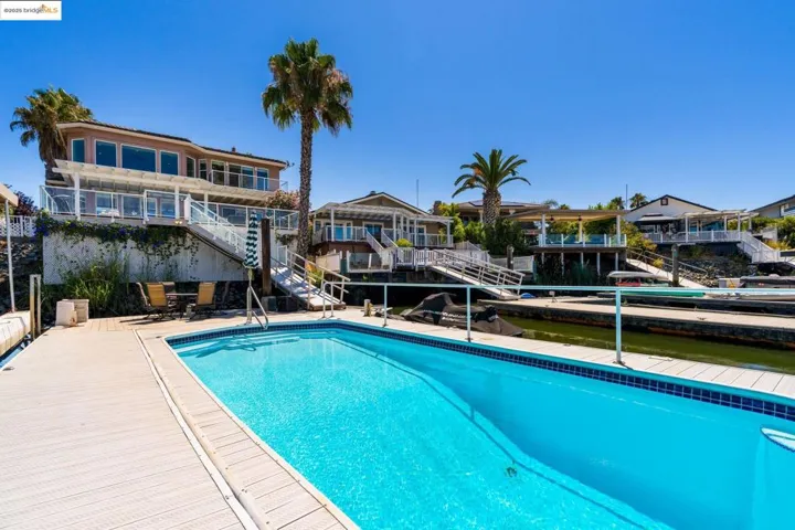 Swimming pool featuring stairs and a patio